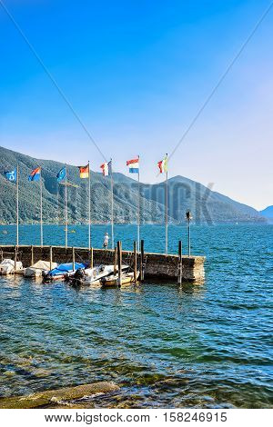 Ascona Switzerland - August 23 2016: Motor Boats at the embankment in Ascona luxurious resort on Lake Maggiore in Ticino canton in Switzerland. People on the background