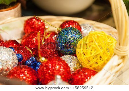 Many colored Christmas balls in a basket colorful Christmas xmasBackground