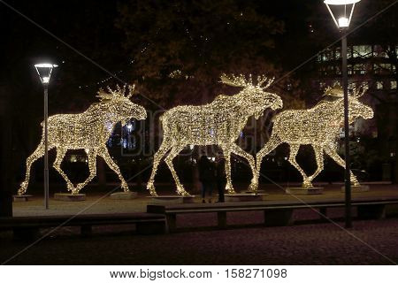 Side view of a herd of Christmas moose made of led light Nybrokajen Stockholm Sweden