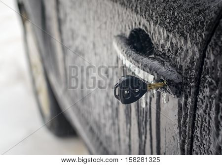 key inserted into the vehicle door lock with a shallow depth of field