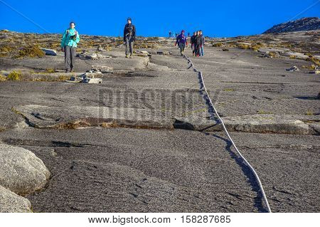 Ranau Sabah Malaysia-March 12, 2016:Mountain climbing rope with background of climbers seen at Timpohon trail to Laban Rata of Mount Kinabalu.Climbing season officially start on Dec 1,2015 after closure due to earthquake.