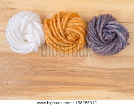 Wool bun swatches colored by henna and indigo and control white sample