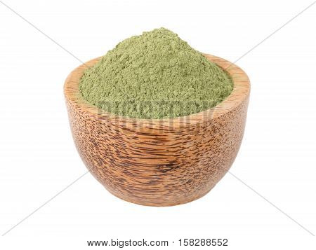 Indigo indigofera tinctoria powder in the wooden bowl isolated on white