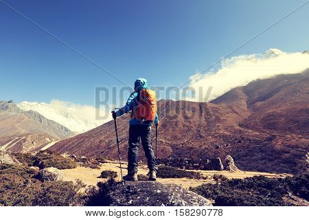 young woman backpacker enjoy the view on himalaya mountains