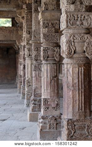 DELHI, INDIA - FEBRUARY 13 : Columns with stone carving in courtyard of Quwwat-Ul-Islam mosque, Qutab Minar complex, Delhi, India on February 13, 2016.