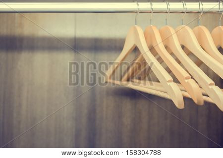 Clothes hanger in wardrobe. Vintage process. Close up with copy space.