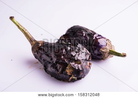 roasted eggplants or bhuna baigan in hindi, isolated over white background, selective focus