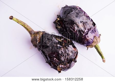 roasted eggplants or bhuna baigan in hindi, isolated over white background, selective focus