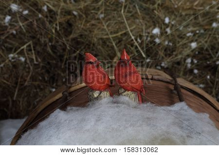 decorative birds Snigir sit on simulated snow