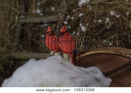 decorative birds Snigir sit on simulated snow