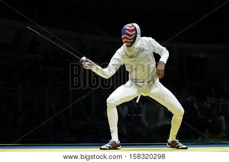 RIO DE JANEIRO, BRAZIL - AUGUST 12, 2016: Fencer Miles Chamley-Watson of United States competes in the Men's team foil of the Rio 2016 Olympic Games at the Carioca Arena 3
