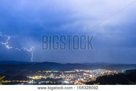 Thunder storm over the city and blue skies