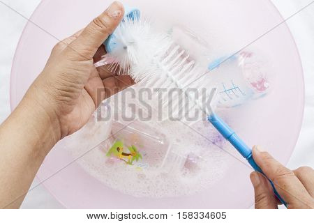 baby bottles it was clear that a disinfectant in water cleaning solution with bottle brush and hand holding clean