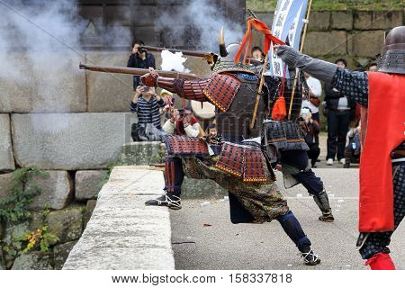 KAGAWA, JAPAN - NOVEMBER 20: Ancient firelock rifle fighters at Marugame Historical battle Festival, event dedicated to Japanese culture and tradition at Marugame-castle on November 20, 2016 in Japan.