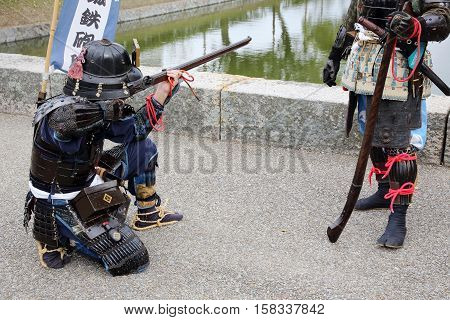 KAGAWA, JAPAN - NOVEMBER 20: Ancient firelock rifle fighters at Marugame Historical battle Festival, event dedicated to Japanese culture and tradition at Marugame-castle on November 20, 2016 in Japan.