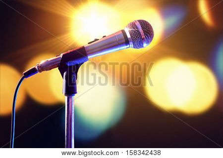 Microphone On Microphone Stand With Lights In The Background