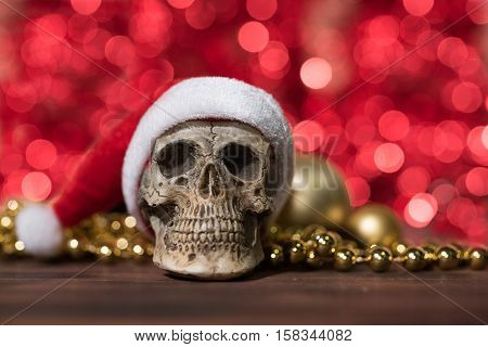 Santa claus skull with gold christmas balls and golden ornament over red circle blurred bokeh background with copy space Merry xmas and Happy new year concept