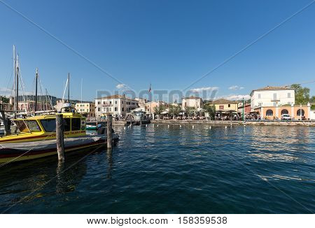 BARDOLINO, ITALY - MAY 4, 2016: Bardolino attractive old town on the Veronese shore of Lake Garda. Its downtown is lined with shops bars restaurants and pizzerias.