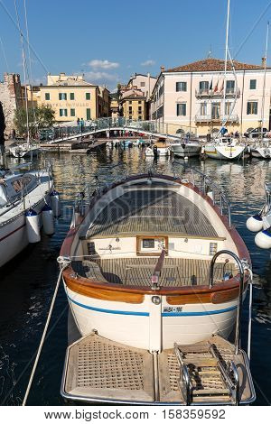 BARDOLINO, ITALY - MAY 4, 2016: Sailboats and fishing boats at Porto di Bardolino harbor on The Garda Lake . Italy