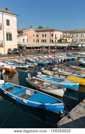 BARDOLINO, ITALY - MAY 4, 2016: Sailboats and fishing boats at Porto di Bardolino harbor on The Garda Lake . Italy