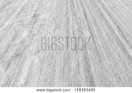 Car tire track in fresh light snow
