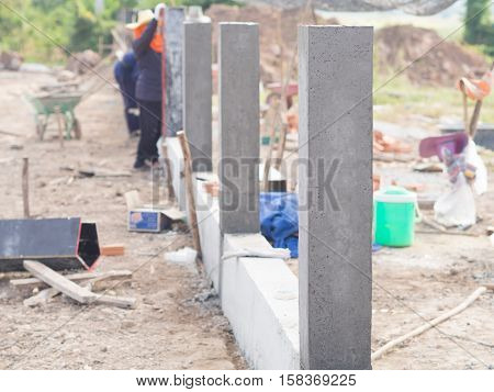 Construction Workers Collaborating In The Unstrap Cement Formwork.