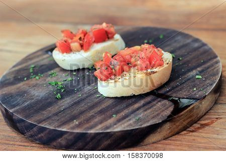 itailian starter food Bruschetta on wood plate