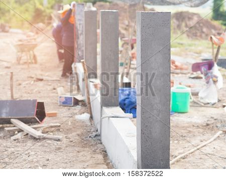 Construction Workers Collaborating In The Unstrap Cement Formwork.