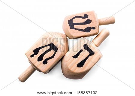 Wooden dreidels for Hanukkah on white background
