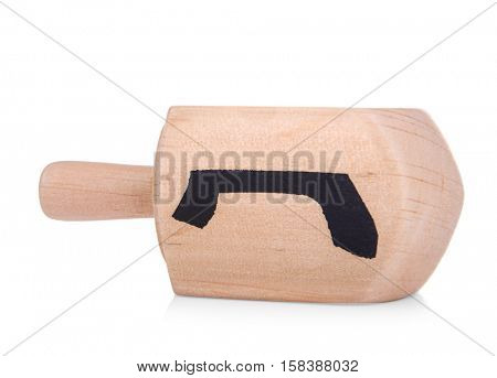 Wooden dreidel for Hanukkah on white background