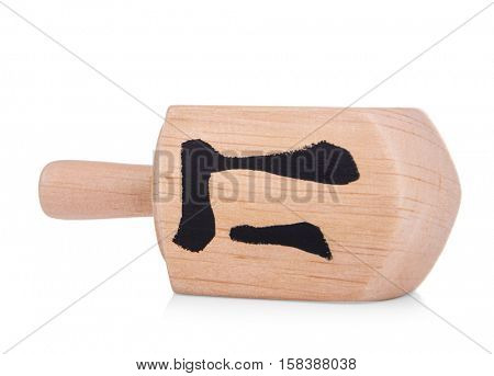 Wooden dreidel for Hanukkah on white background