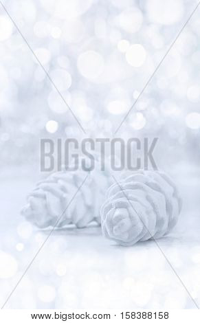 Silver and white Christmas ornaments on glitter bokeh background with space for text. Xmas and Happy New Year theme