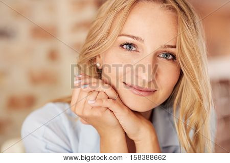 Closeup portrait of an attractive young blonde woman with a perfect complexion relaxing at home