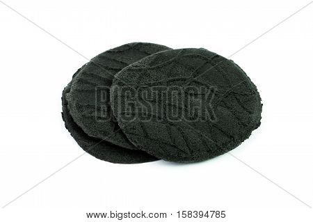 Organic active carbon charcoal cookies on white background.