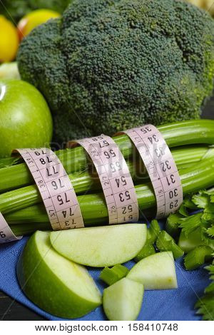 Green vegetables and fruits - celery shoots and apples healthy fitness diet concept