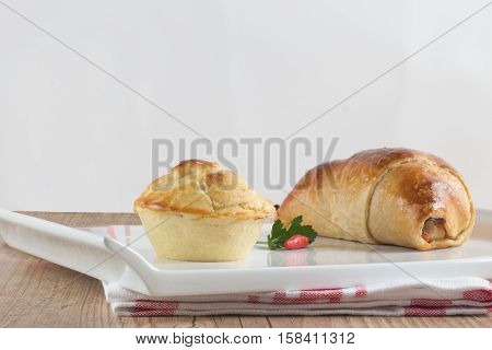 Traditional Brazilian Empada over a wooden table. Empadinha