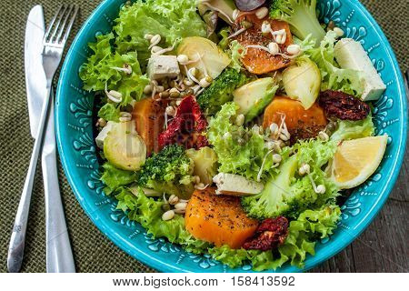 Salad with sweet potatoes dried tomatoes avocado broccoli brussels sprouts tofu mung bean sprouts. Perfect for the detox diet or just a healthy meal. Love for a healthy raw food concept.