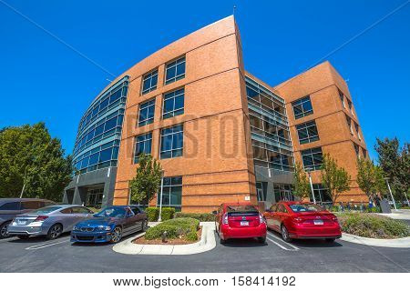Mountain View, California, United States - August 15, 2016: Google Building 1950 with cars parked in front. Google is a multinational corporation specializing in Internet services and products.