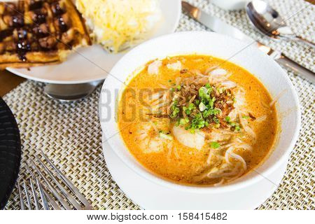 authentic singaporean laksa with a lot of seafoods