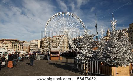 France Marseille - November 19 2015: Tradishional Christmas market with ferris wheel in Old port (Vieux-Port). Marseille is France's largest city on the Mediterranean coast and largest commercial port.