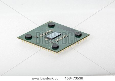 CPU. Modern computer processor unit. The microprocessor is located on a green PCB. 4 mounting pads on the card and microelements around the processor chip. Isolated on white background.
