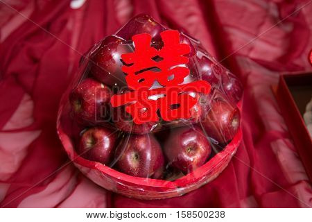 Pile stack of red apple gift with shuang xi double happiness symbol