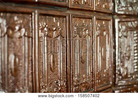 Brown tiles on the stove surface. Close up.