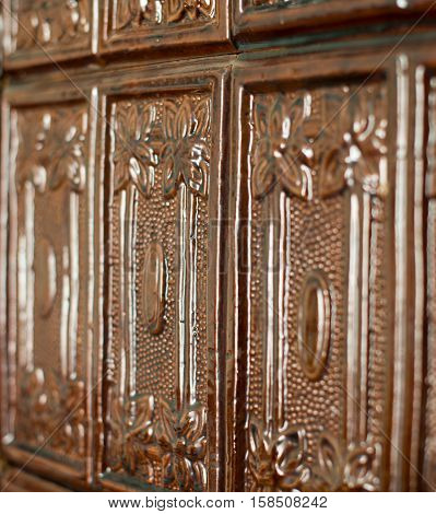 Brown tiles on the stove surface. Close up.