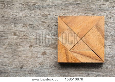 puzzle in square shape on wooden table
