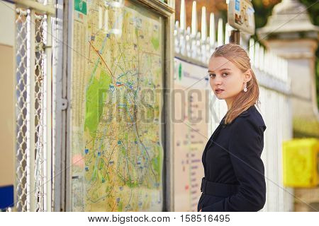 Parisian Woman Near The Subway Plan, Looking For The Direction