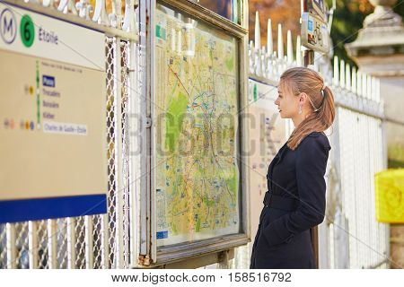 Parisian Woman Near The Subway Plan, Looking For The Direction