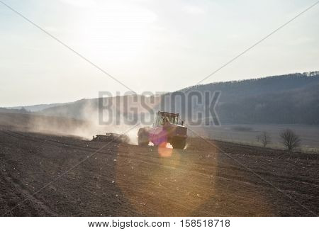 Harrowing the soil with disc harrows in spring in Ukraine.