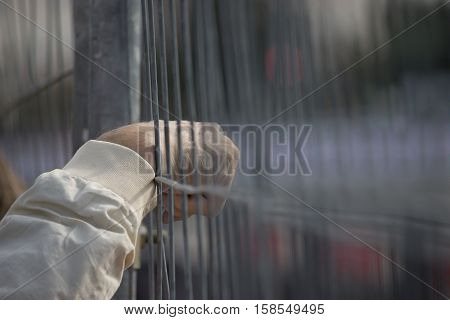 oldman hand through the fence selective focus