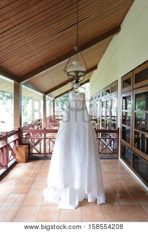 Beautiful white wedding gown hanging before a ceremony.